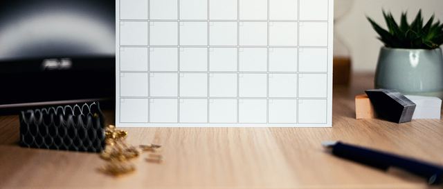 A paper calendar open on a desk